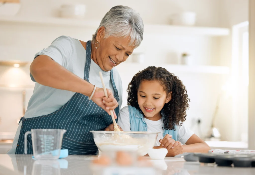 A woman and girl are making cake together.