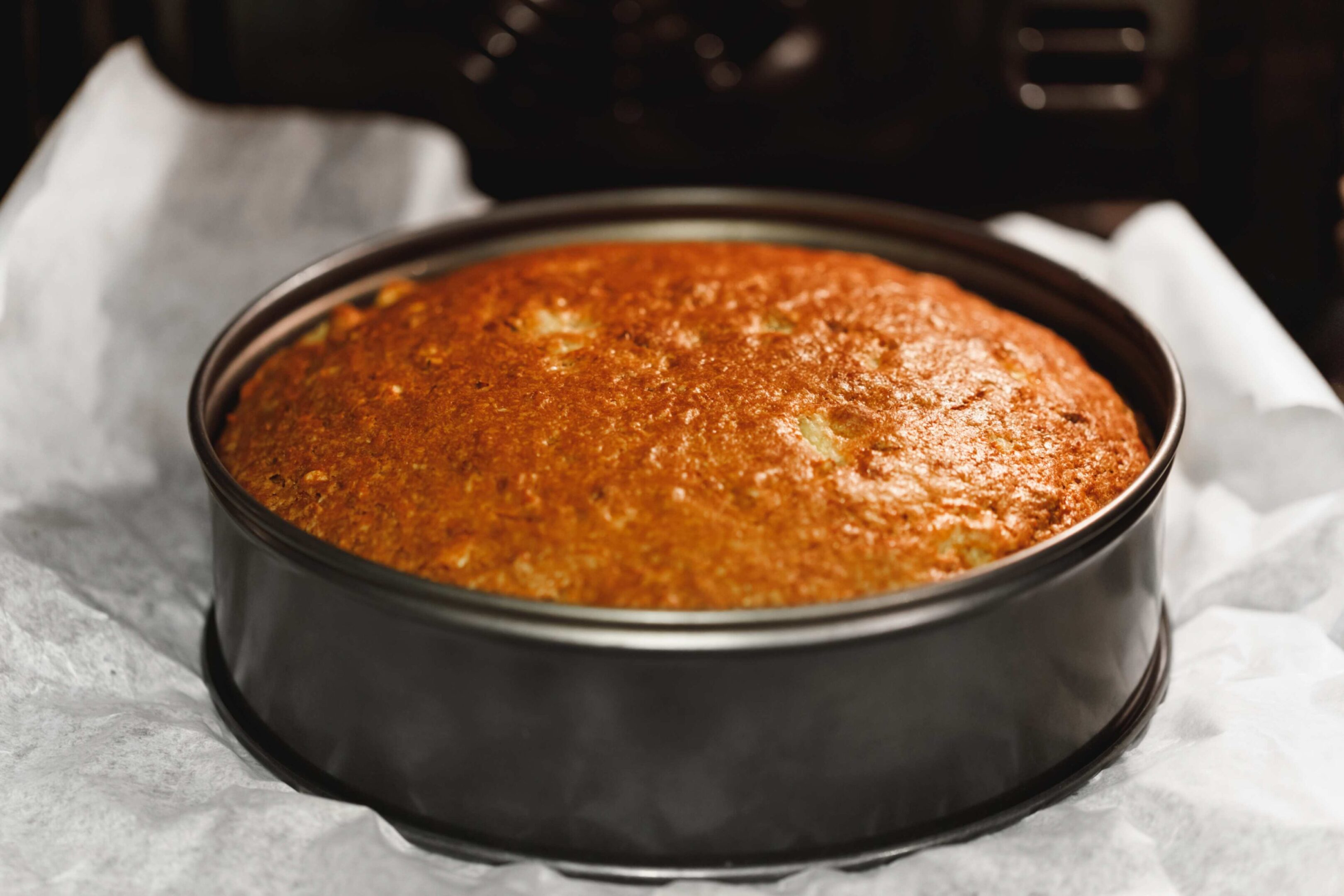 A cake in a pan on top of the stove.